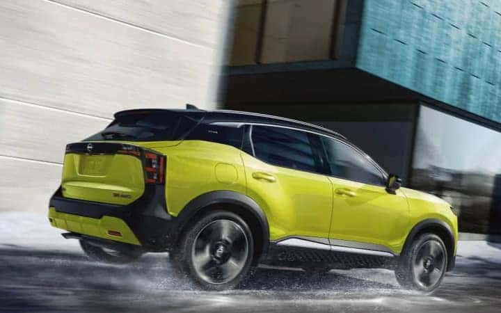 Yellow Nissan SUV driving on dirt road