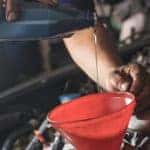 Mechanic changing oil in a car