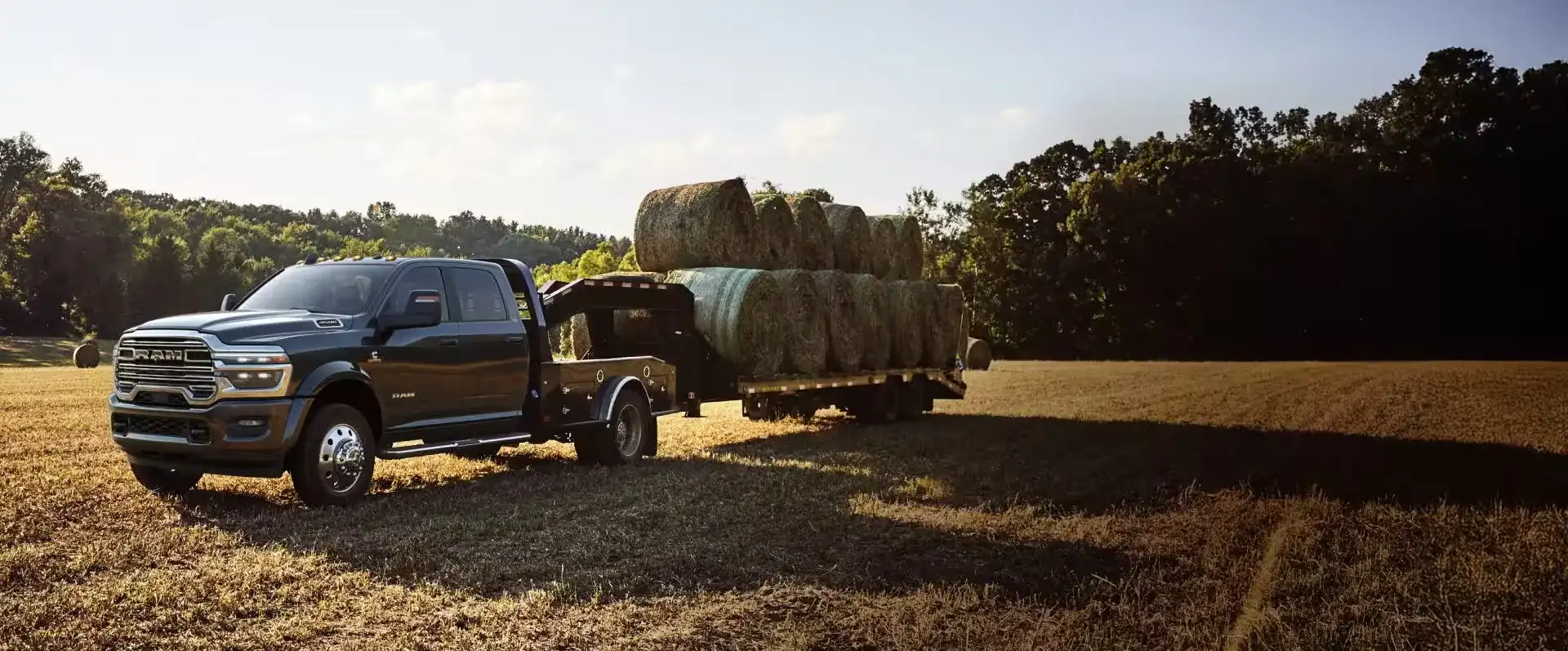 Ram 5500 Chassis Cab with a hay-hauling flatbed upfit working in a farm field