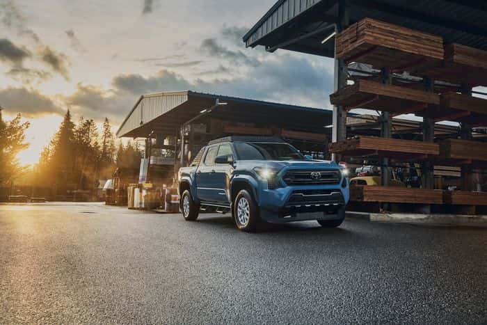 Blue Toyota Tacoma SR5 parked at a lumber yard
