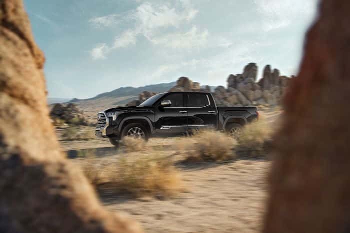 Black Toyota Tundra 1794 Edition hybrid traveling through desert terrain