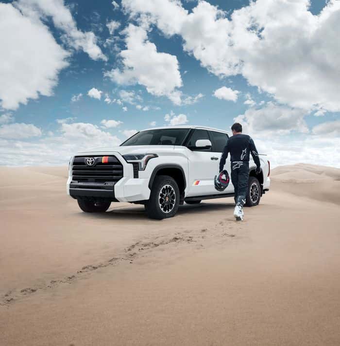 White Toyota Tundra and driver in a desert setting
