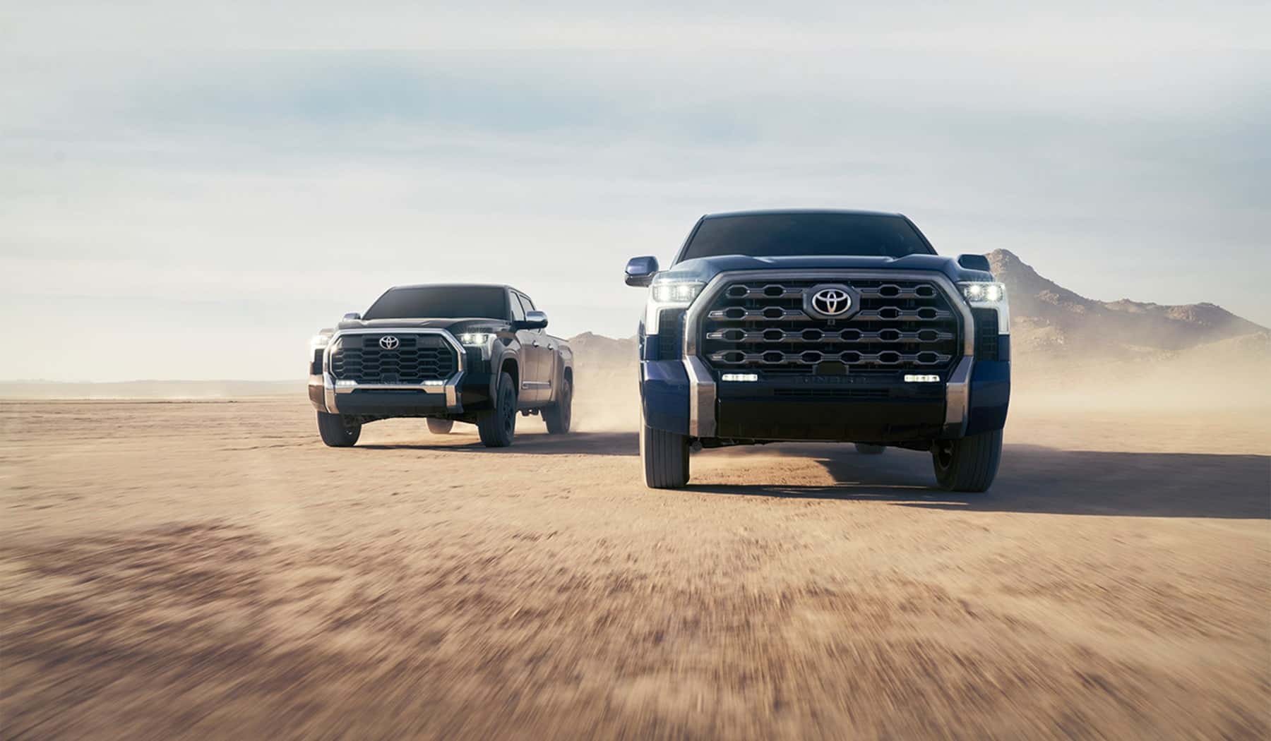 Toyota Tundra trucks on an open desert road