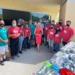 Toyota of the Desert employees showing off the hygiene kits they put together