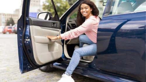 woman getting out of vehicle