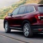 Red 2020 Honda Pilot on Highway Corner