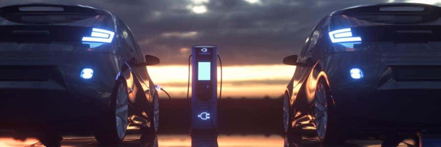 Electric Cars Plugged In and Charging at Sunset