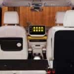 interior view of the VW ID Buzz van, with yellow interior accents and the backseats folded down