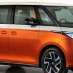 exterior of an orange VW ID Buzz in front of a white background