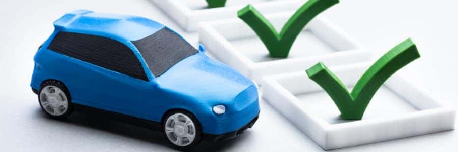 a blue toy car with 3D checkmarks filling adjacent squares