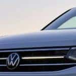 a Tiguan at dusk with LED headlights on