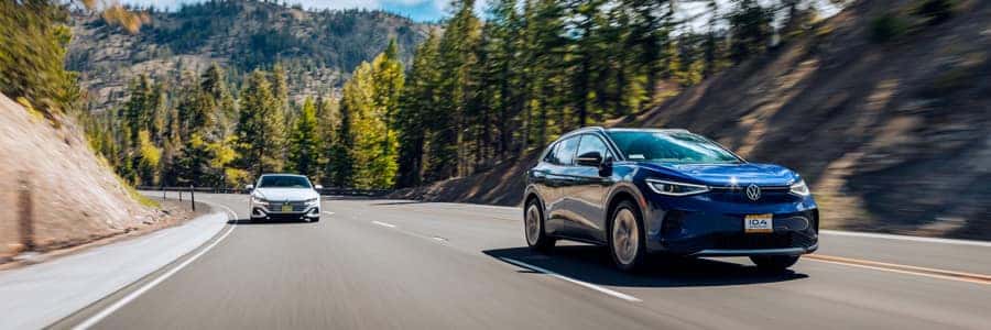 volkswagen car driving down a road volkswagen car driving down a road