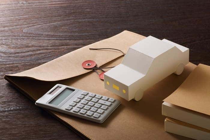 Volvo financing materials, including a calculator and toy car