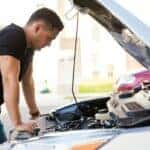 Man looking under hood at Volvo service needs