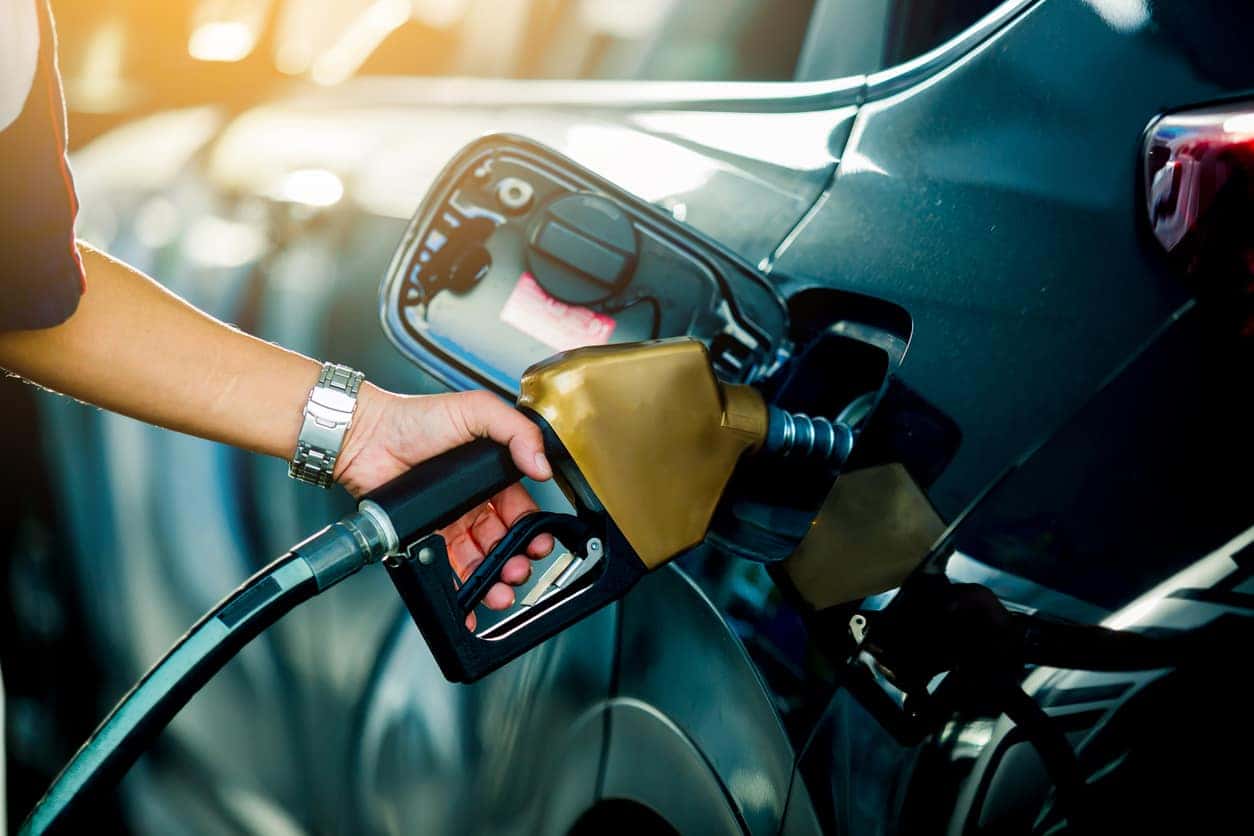 Hand refilling the car with fuel at the refuel station