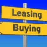 Road sign arrows pointing toward buying and leasing