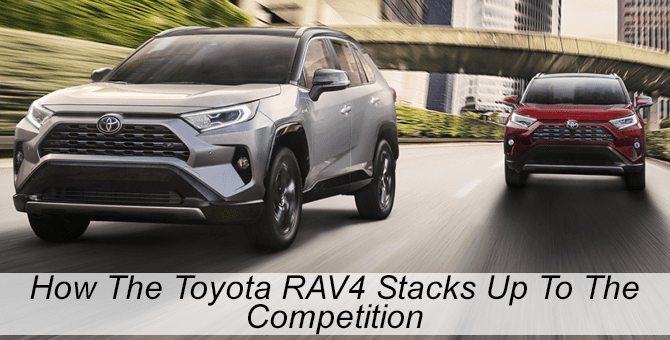 Two RAV4s driving on acity street