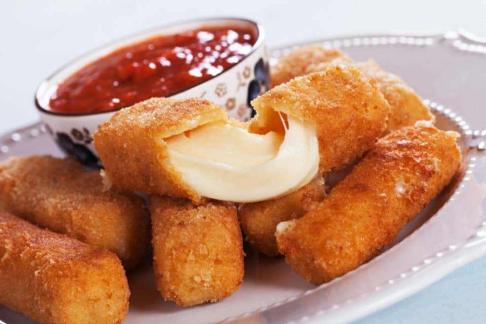 Breaded mozzarella cheese sticks served with tomato sauce