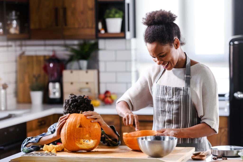 Mother and son carving pumpkin