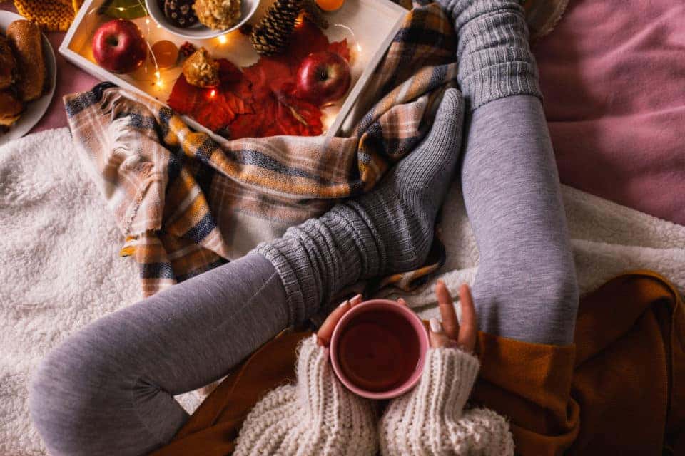 Woman drinking tea in a fall home decor setting