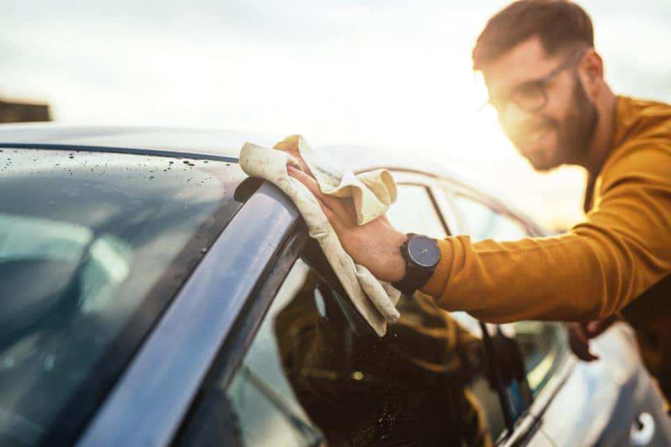 Man cleaning exterior of car