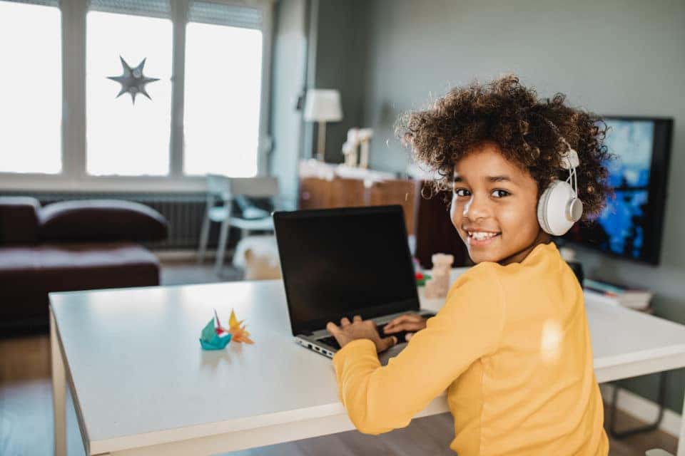 Young woman studying on her computer and using headphones