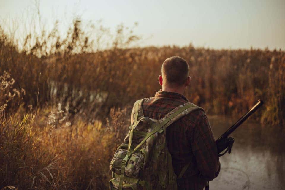 Man with military backpack hunting