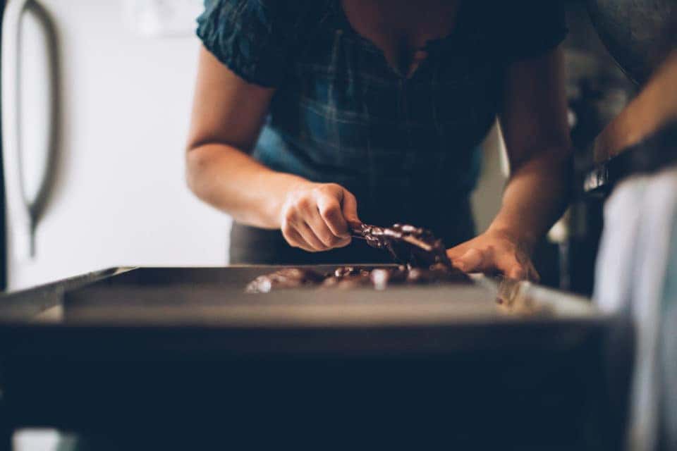 A young woman making brownies