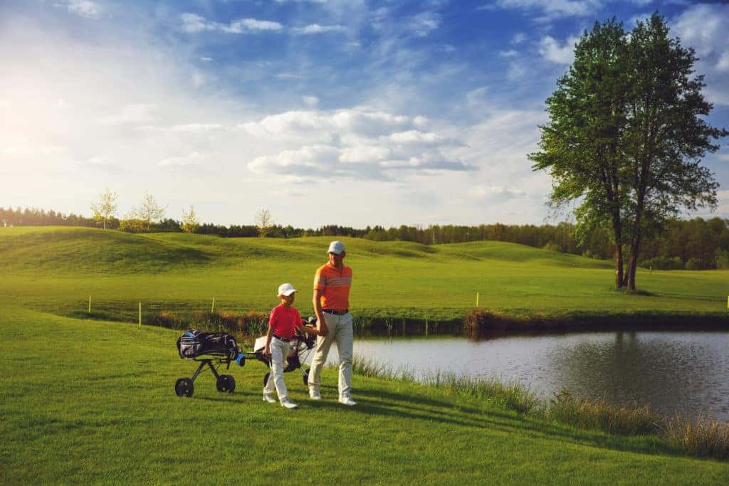 father and son on golf course